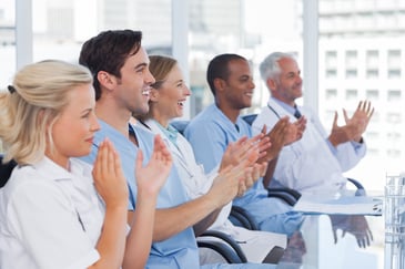 Healthcare team clapping and smiling